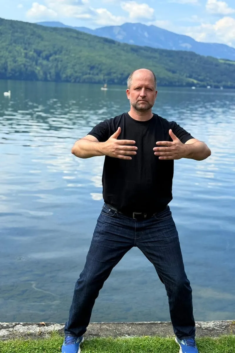 Christian Weidl in horse stance by the lake — Qi Gong in the open air